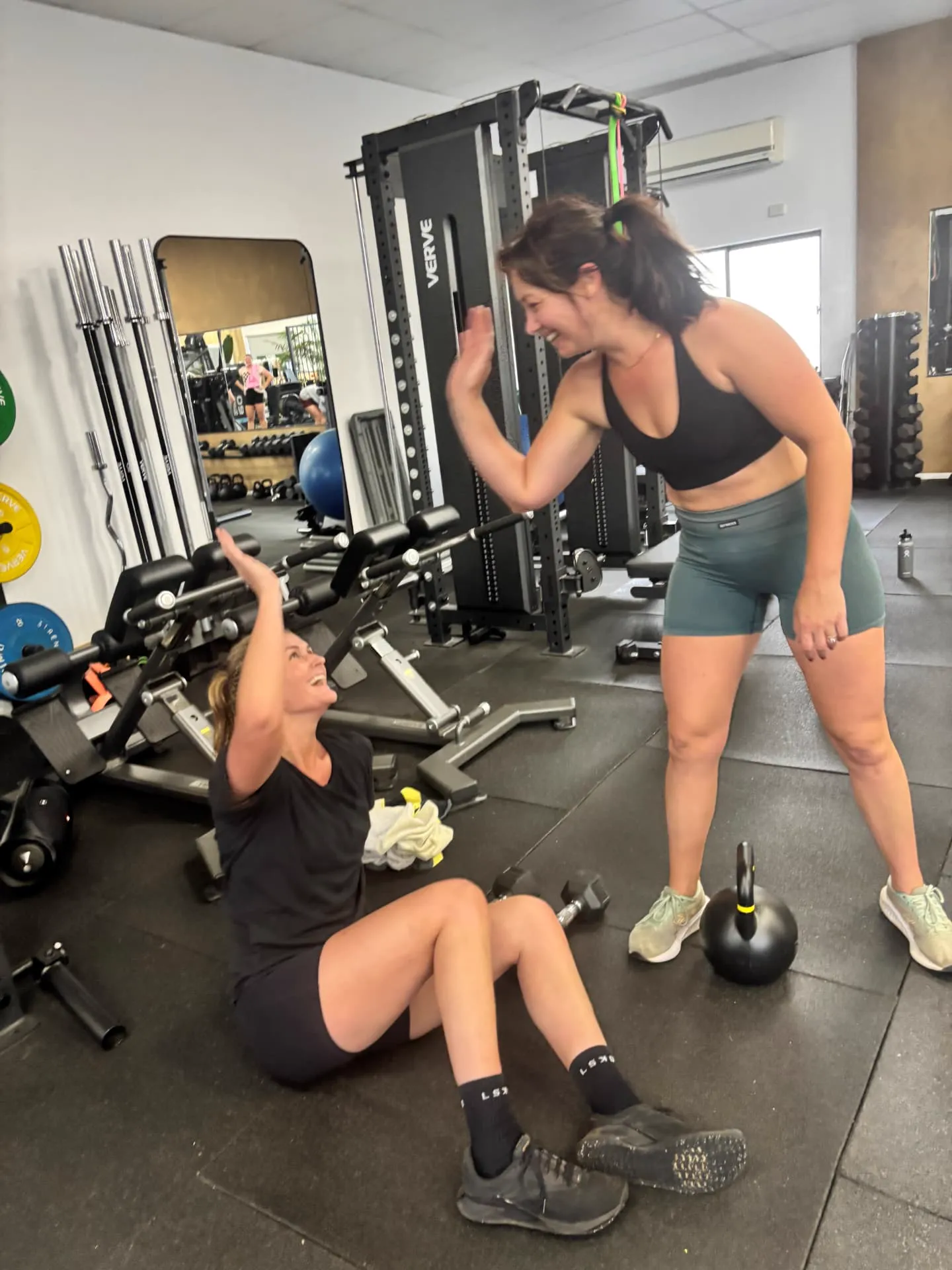 Two members celebrating with a high five between sets